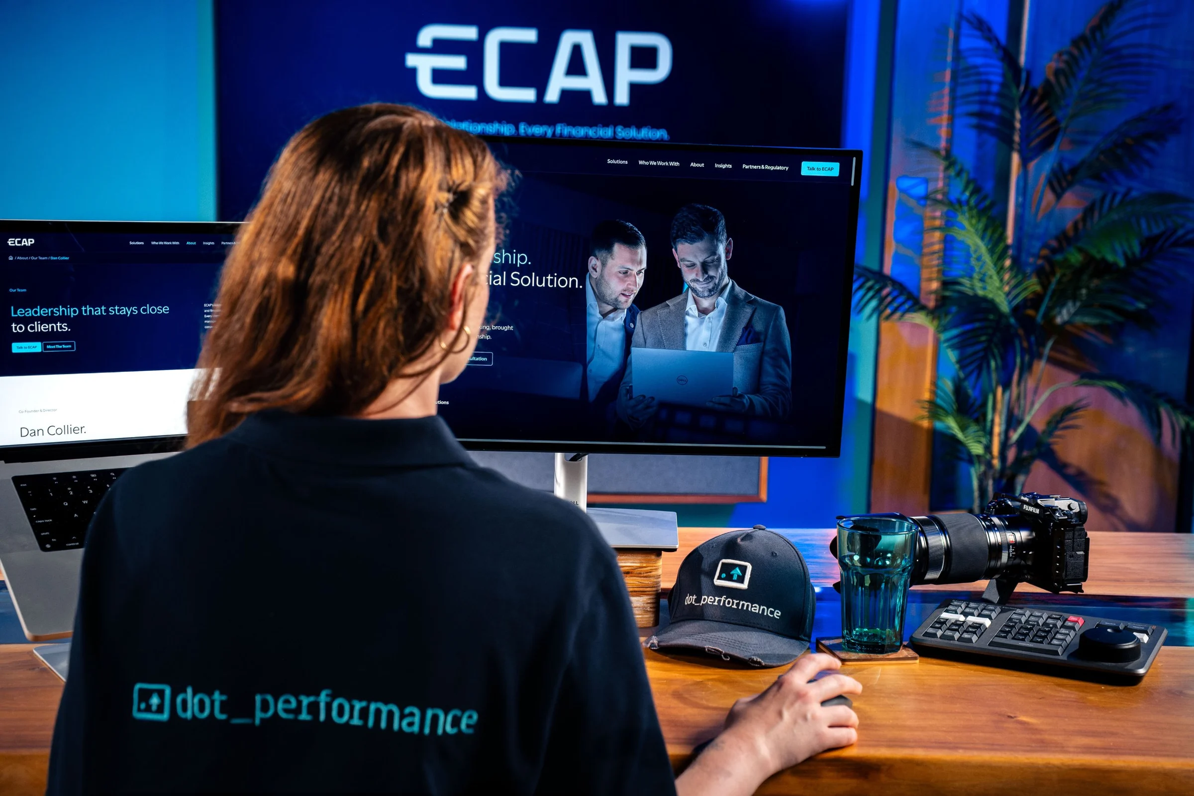 Ella Garvey in the DotPerformance studio, checking the founders’ photography against the ECAP website design
