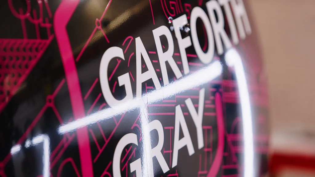 Close-up of the Garforth Gray house mark on the door of the wrapped Mini