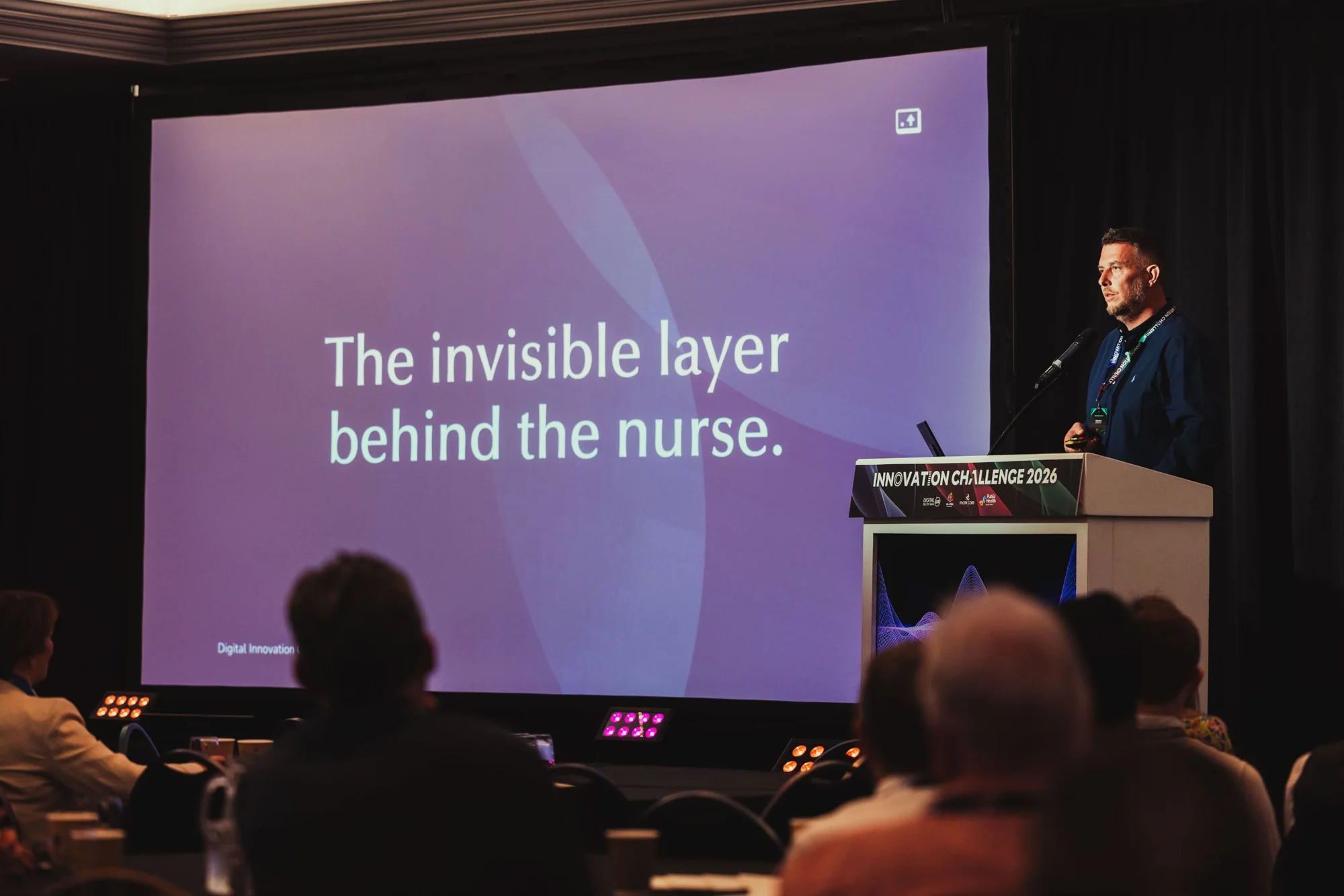 Andy Orton presenting a slide reading The invisible layer behind the nurse