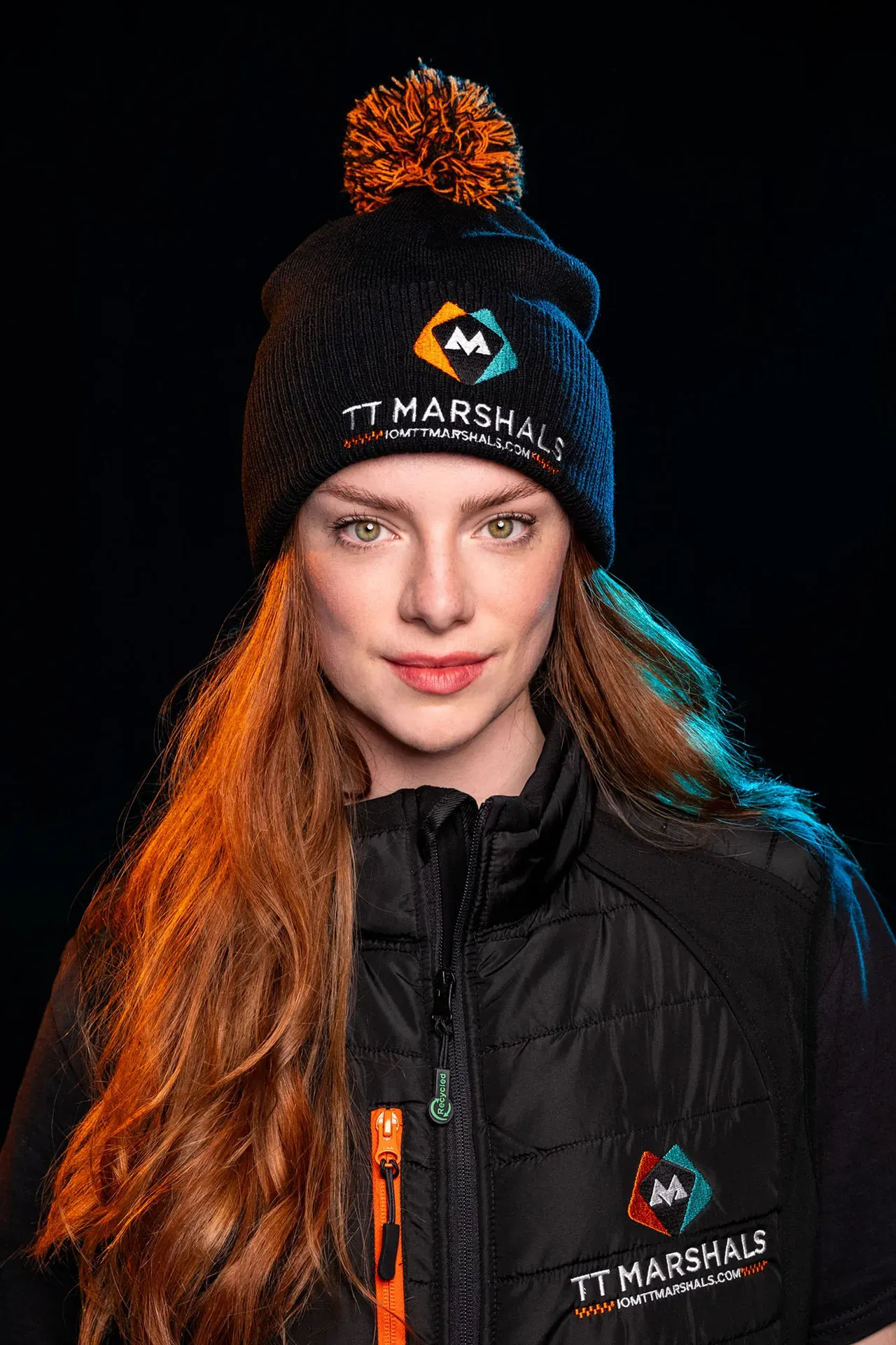 Ella Garvey wearing the TT Marshals bobble hat and padded gilet